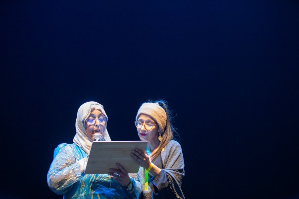 Two women read aloud together